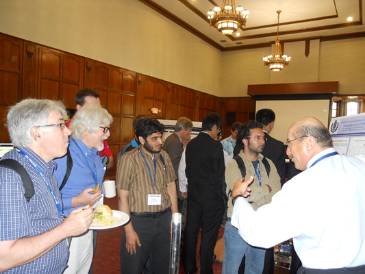 Prof. Nejat Olgac is presenting the research on thermoacoustic instability prediciton and control to an audience including Prof. Erik Verriest (GATECH) (second from left).